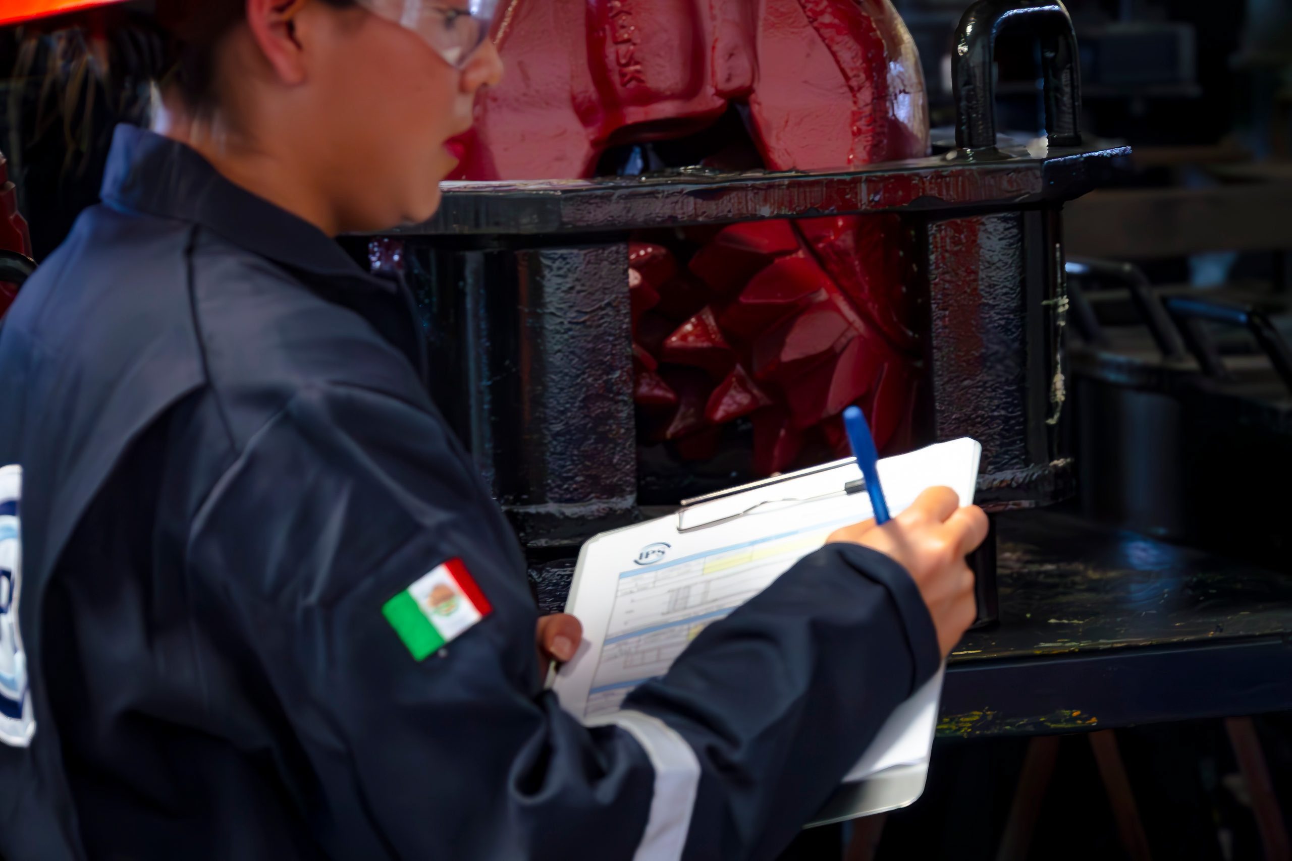 Grupo IPS inspector completing a quality checklist beside a drill bit