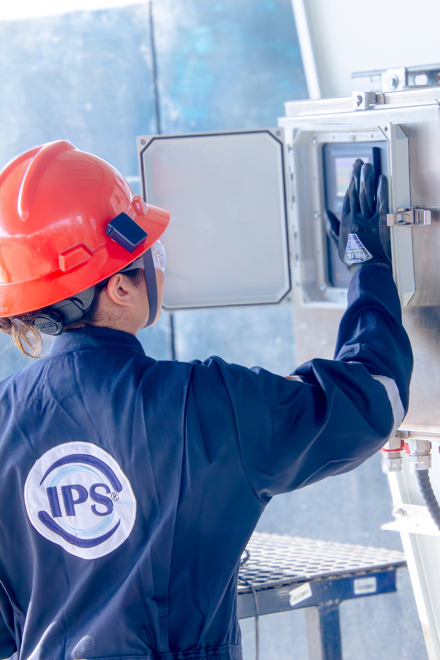 Technician checking a control panel on a separator