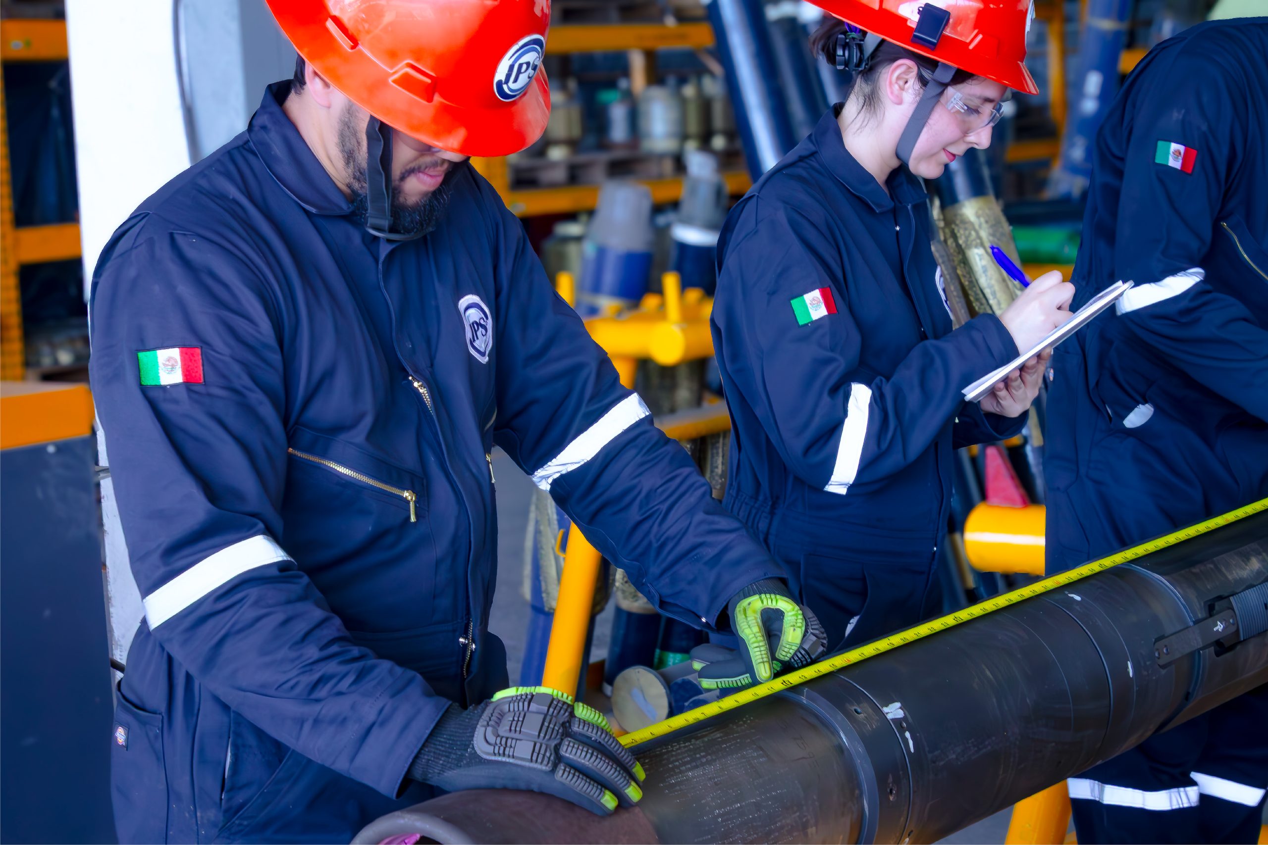 Inspectors in hard hats recording tubular inspection data