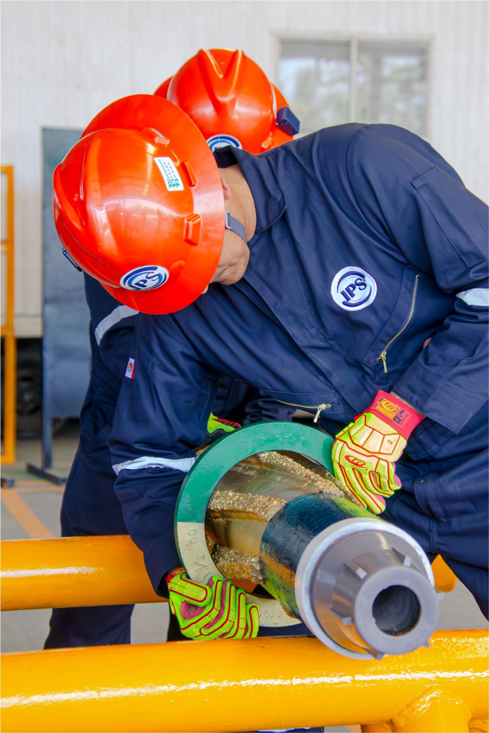 Gloved hands fitting a component on a drilling tool