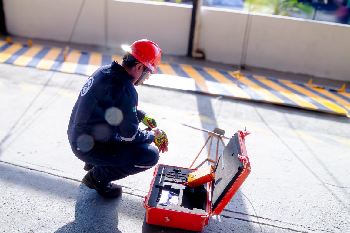 Technician setting up portable testing equipment on site
