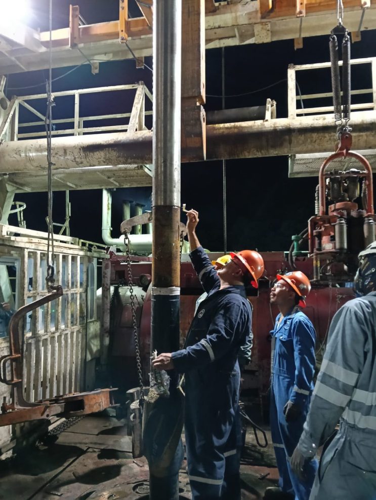 Crew working on the rig floor during well construction