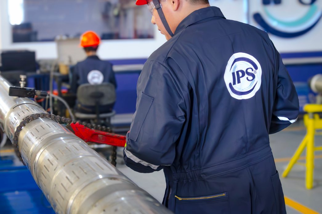 Technician inspecting a downhole tool in the workshop
