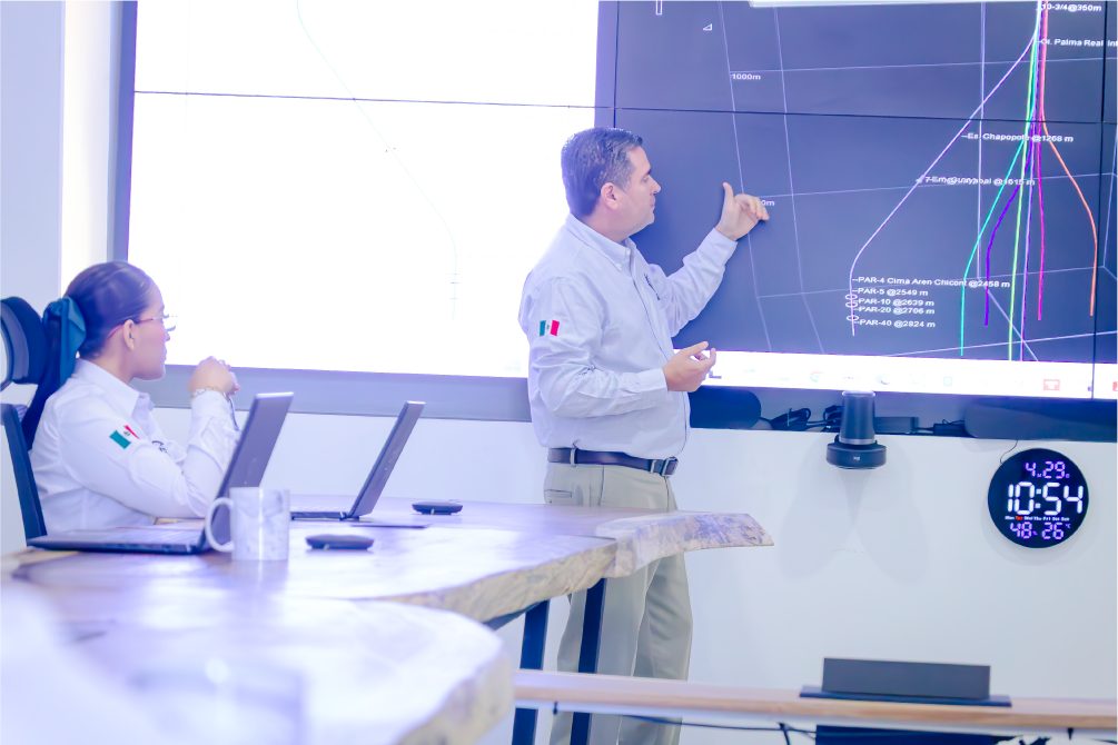 Engineers reviewing a well plan on a screen