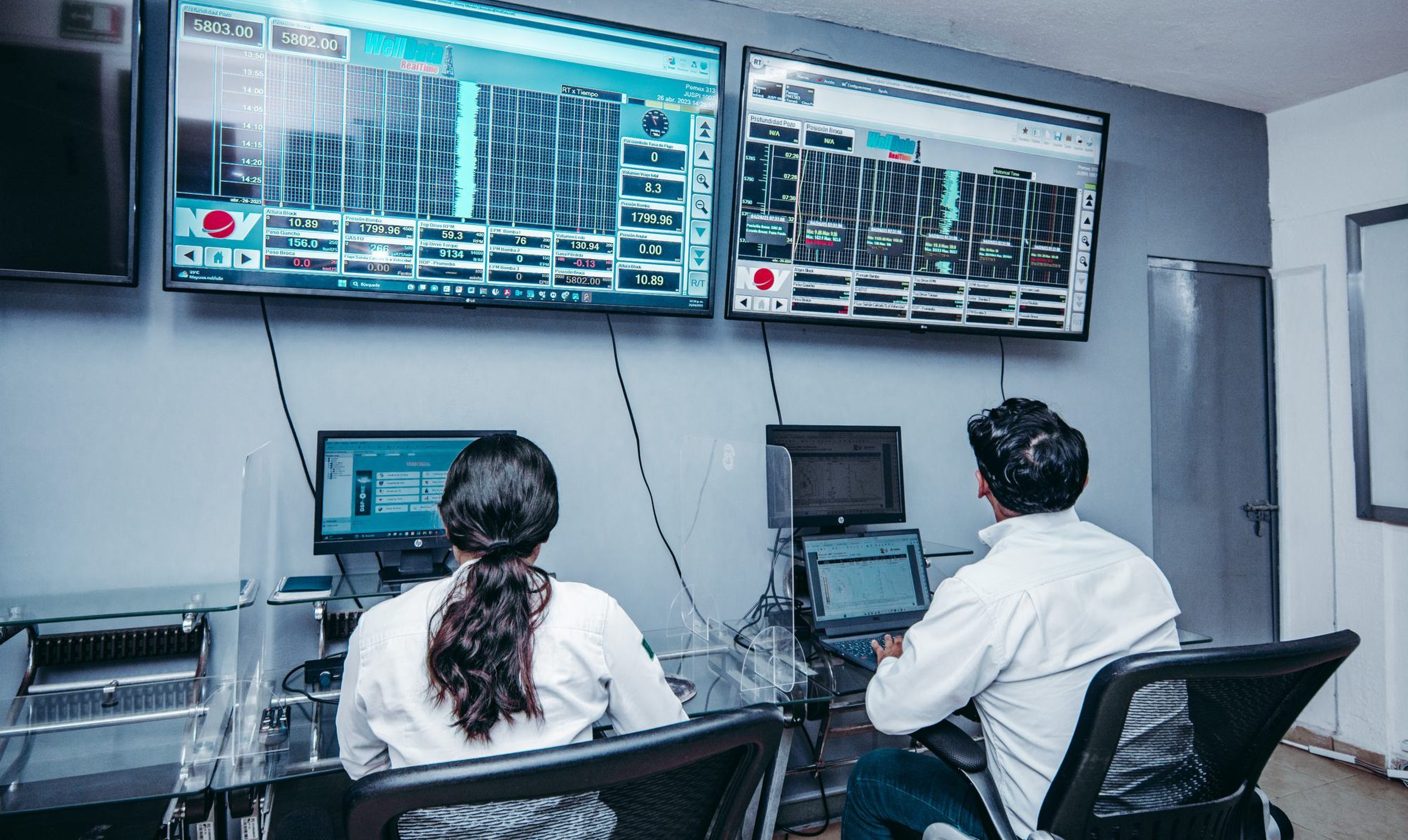 Engineers monitoring real-time downhole data in a control room