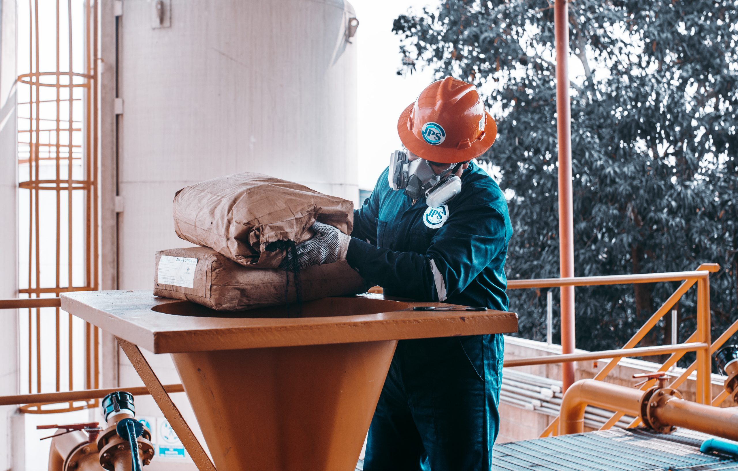 Technician loading stimulation product into a mixing hopper