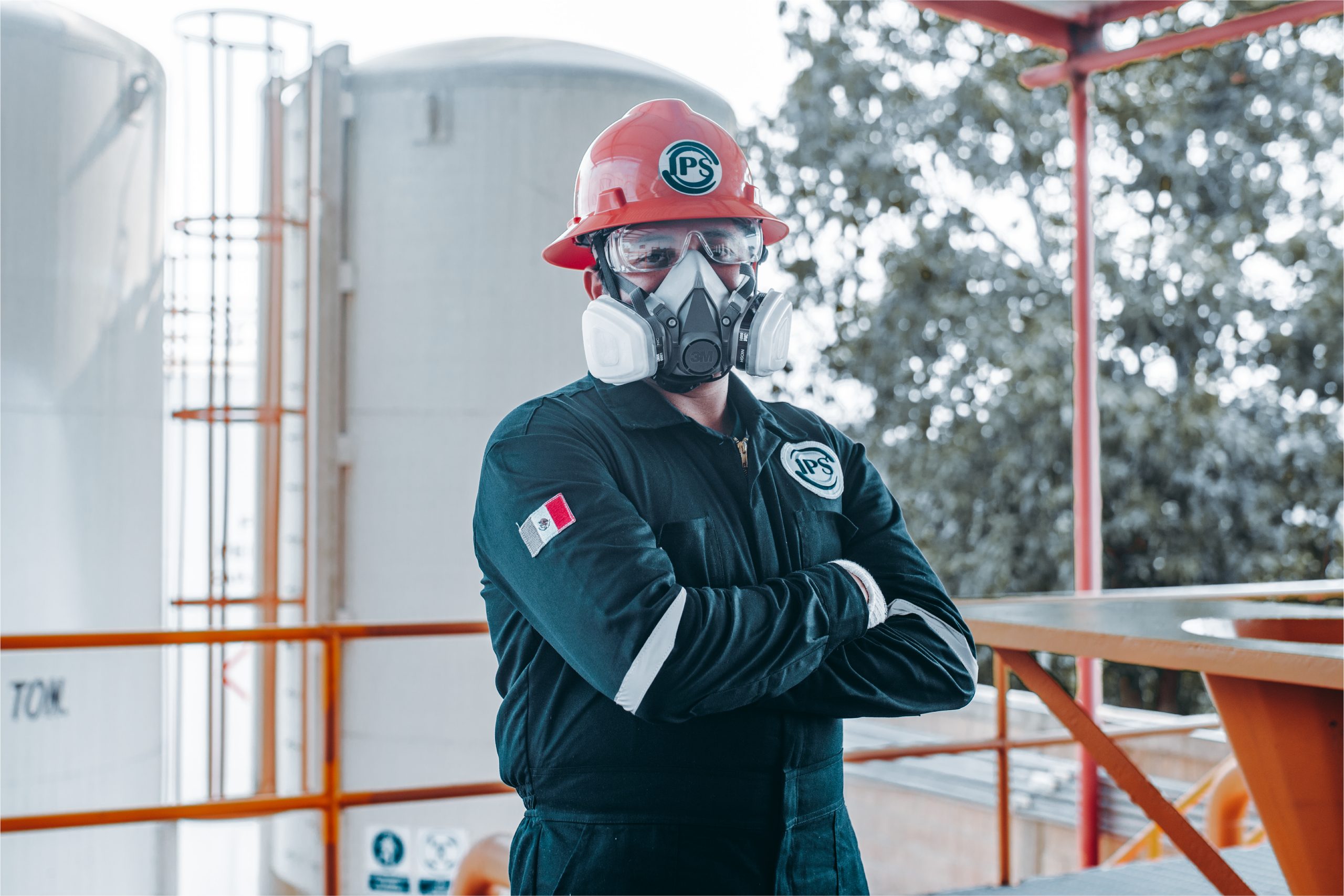 Field technician with respirator standing at the pumping area
