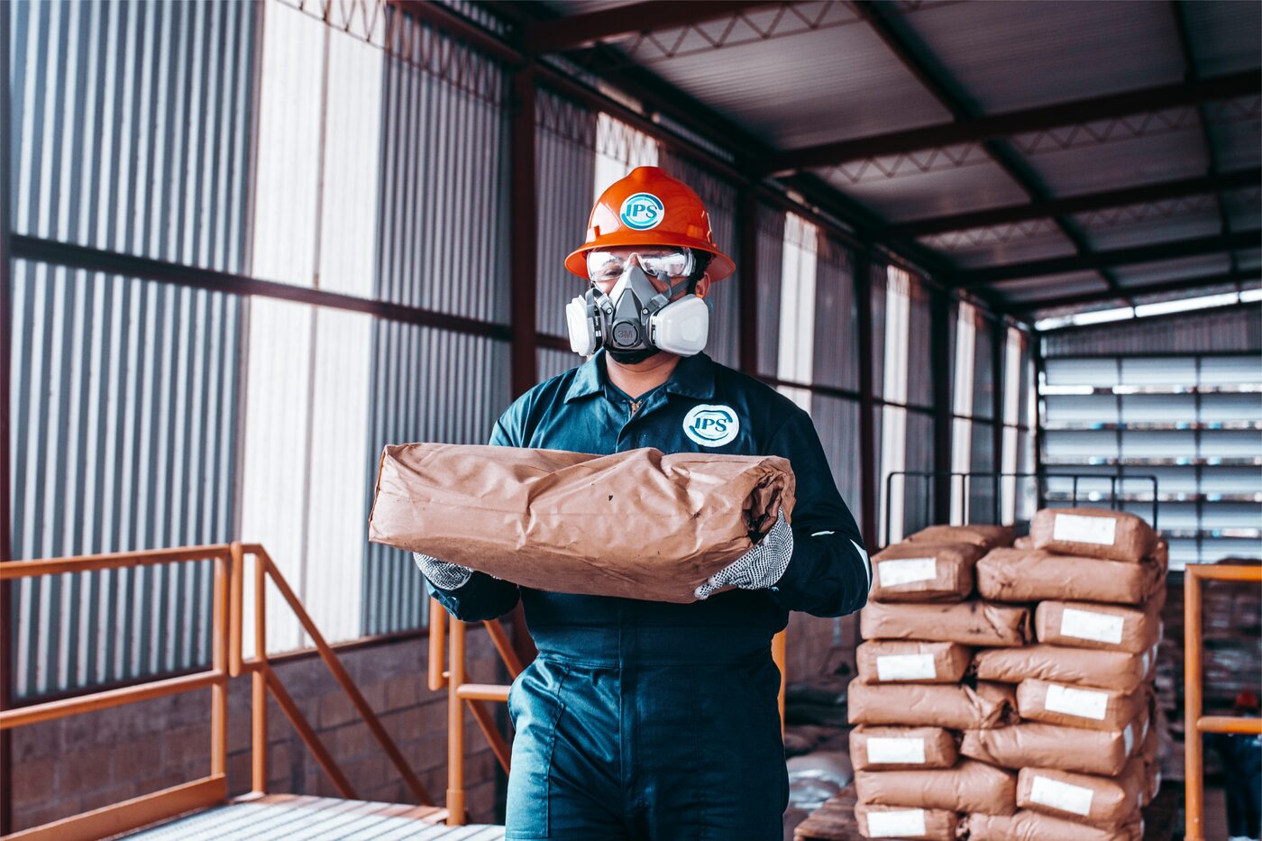 Technician handling drilling fluid additive sacks